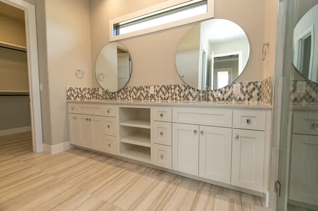 a bathroom with a double vanity sink and mirror