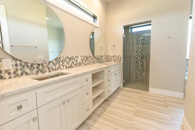 a bathroom with a double vanity sink and mirror