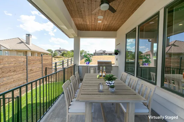 a view of a balcony dining table and chairs