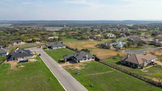 an aerial view of a house with a lake view