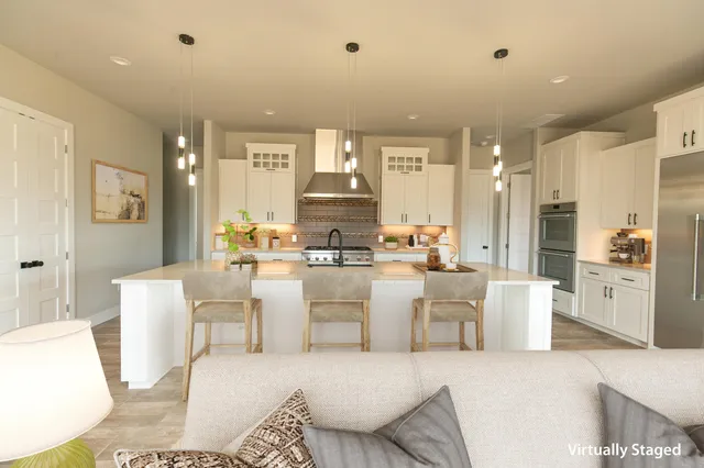 a living room with stainless steel appliances kitchen island granite countertop furniture and a view of kitchen