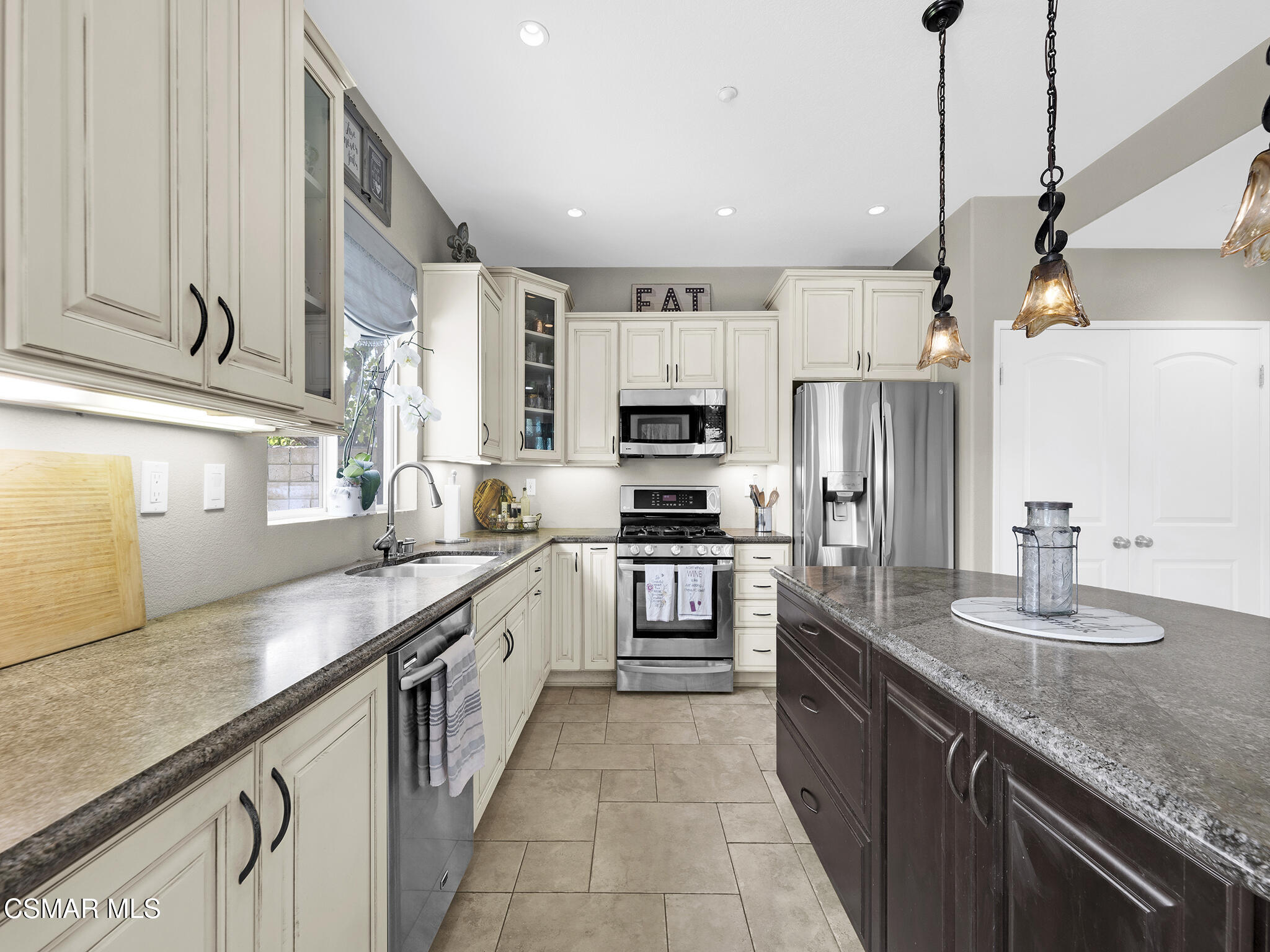 293 Springmist Lane Simi Valley, CA 93065 - Photo 16 of 50 a large kitchen with stainless steel appliances granite countertop a sink counter space cabinets and a counter space
