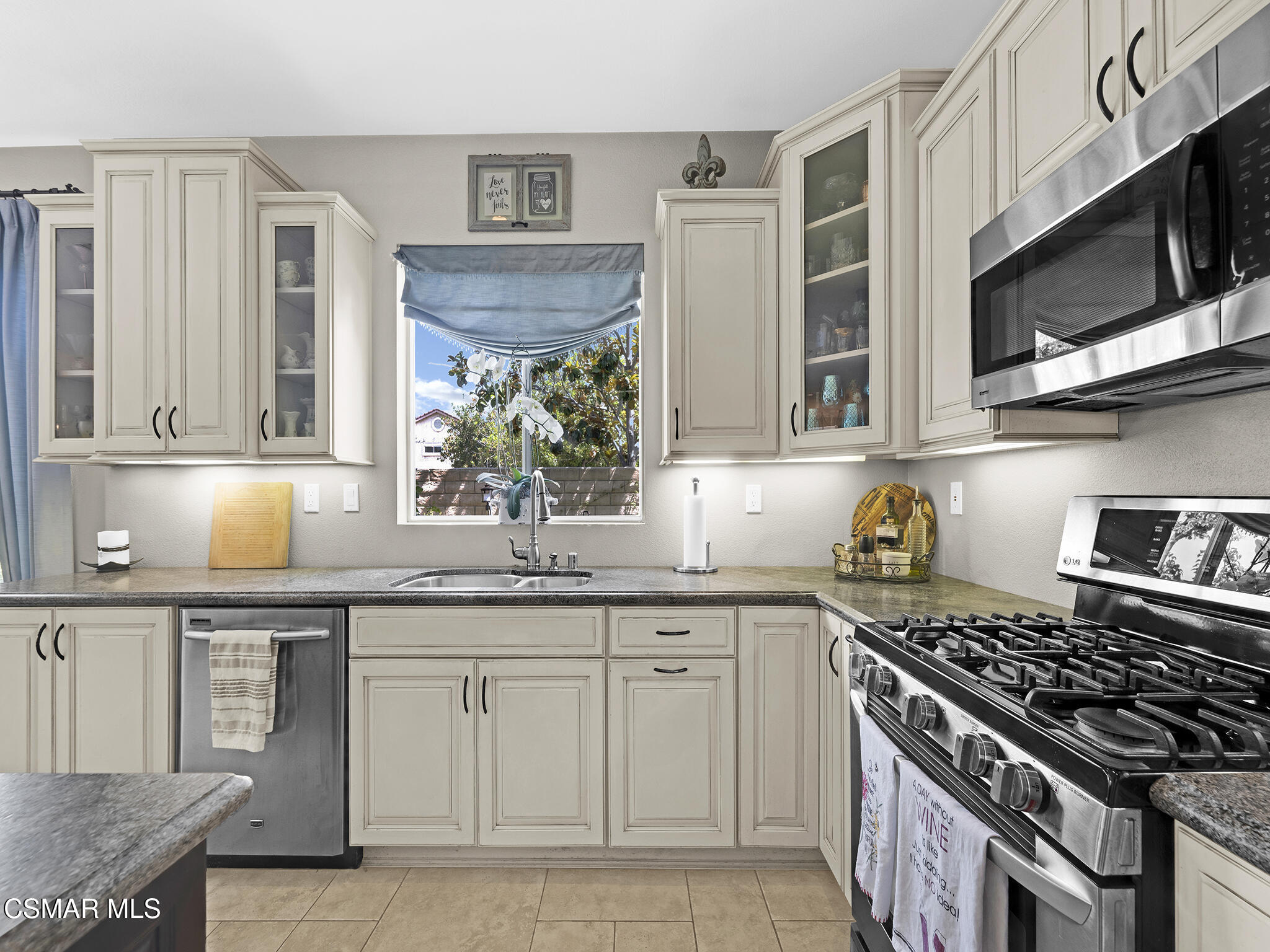 293 Springmist Lane Simi Valley, CA 93065 - Photo 17 of 50 a kitchen with stainless steel appliances granite countertop a stove a sink and a microwave
