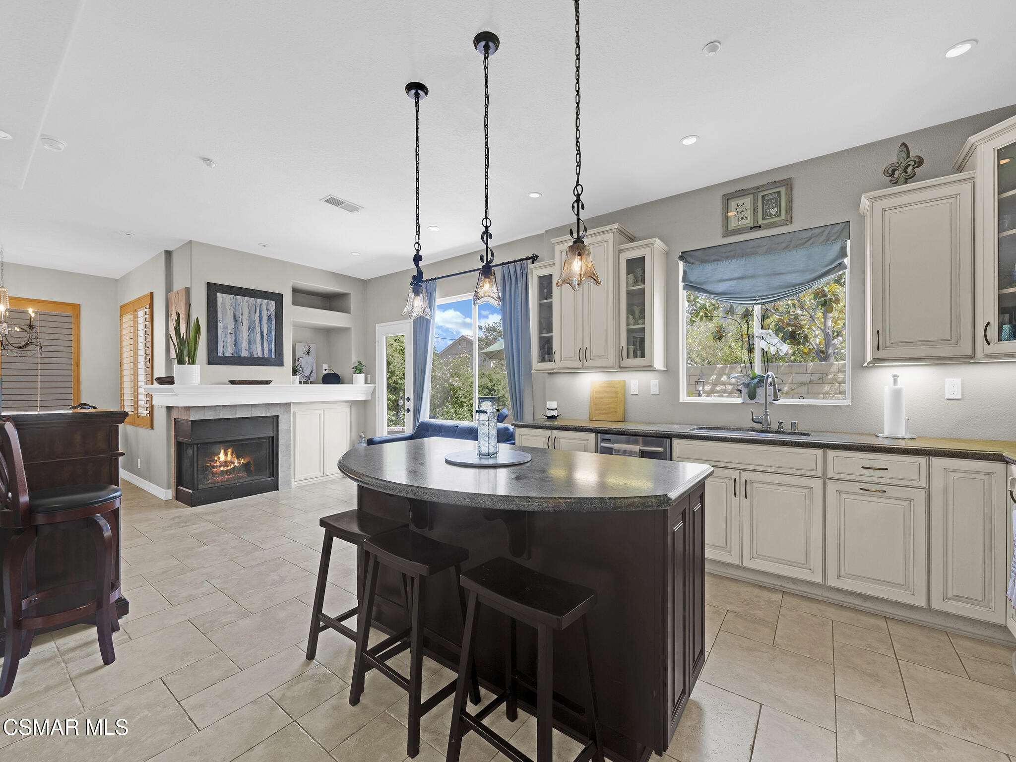 293 Springmist Lane Simi Valley, CA 93065 - Photo 18 of 50 a kitchen with kitchen island granite countertop a sink counter top space appliances and cabinets