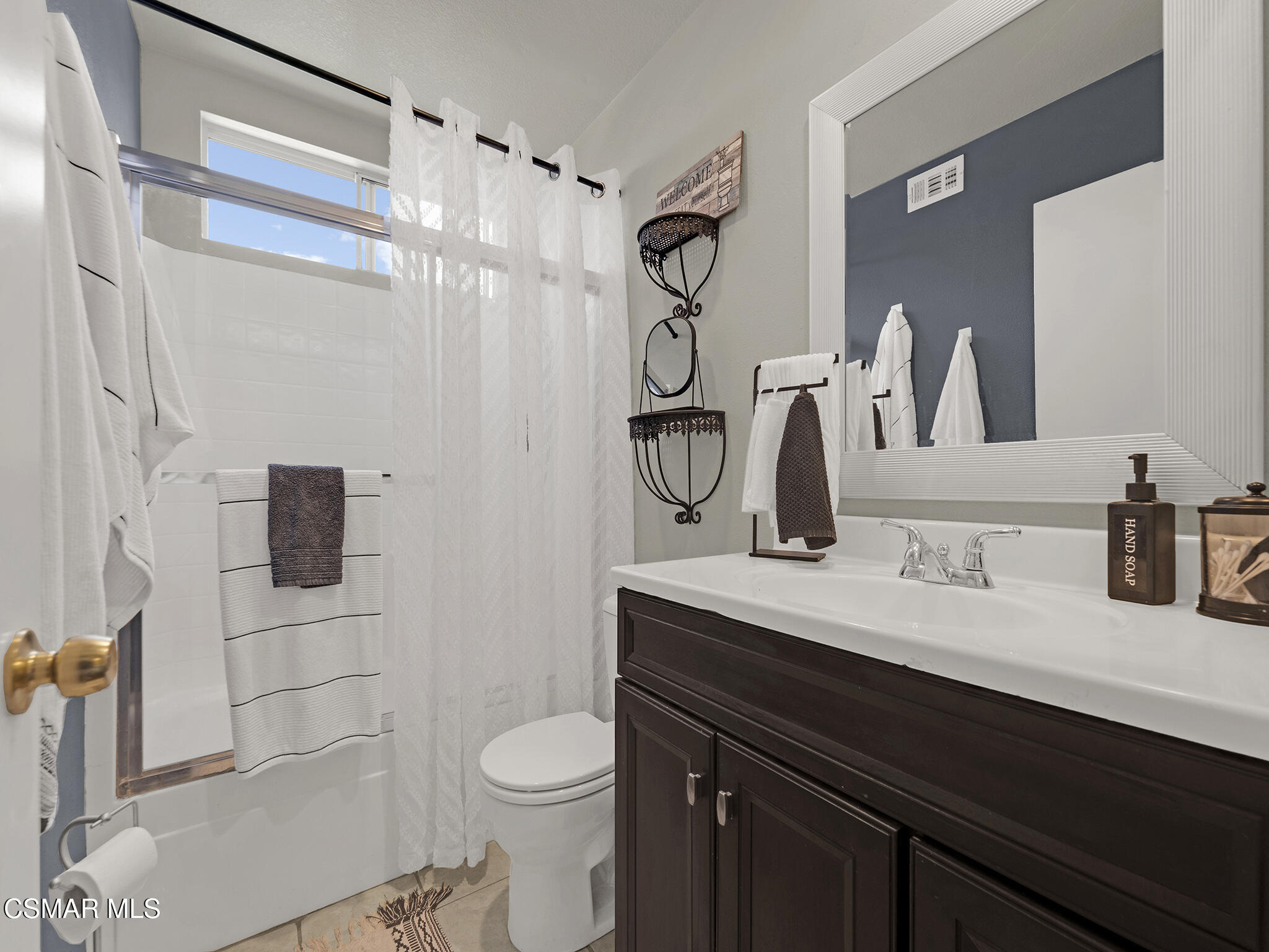 293 Springmist Lane Simi Valley, CA 93065 - Photo 29 of 50 a bathroom with a granite countertop sink a toilet a mirror and shower