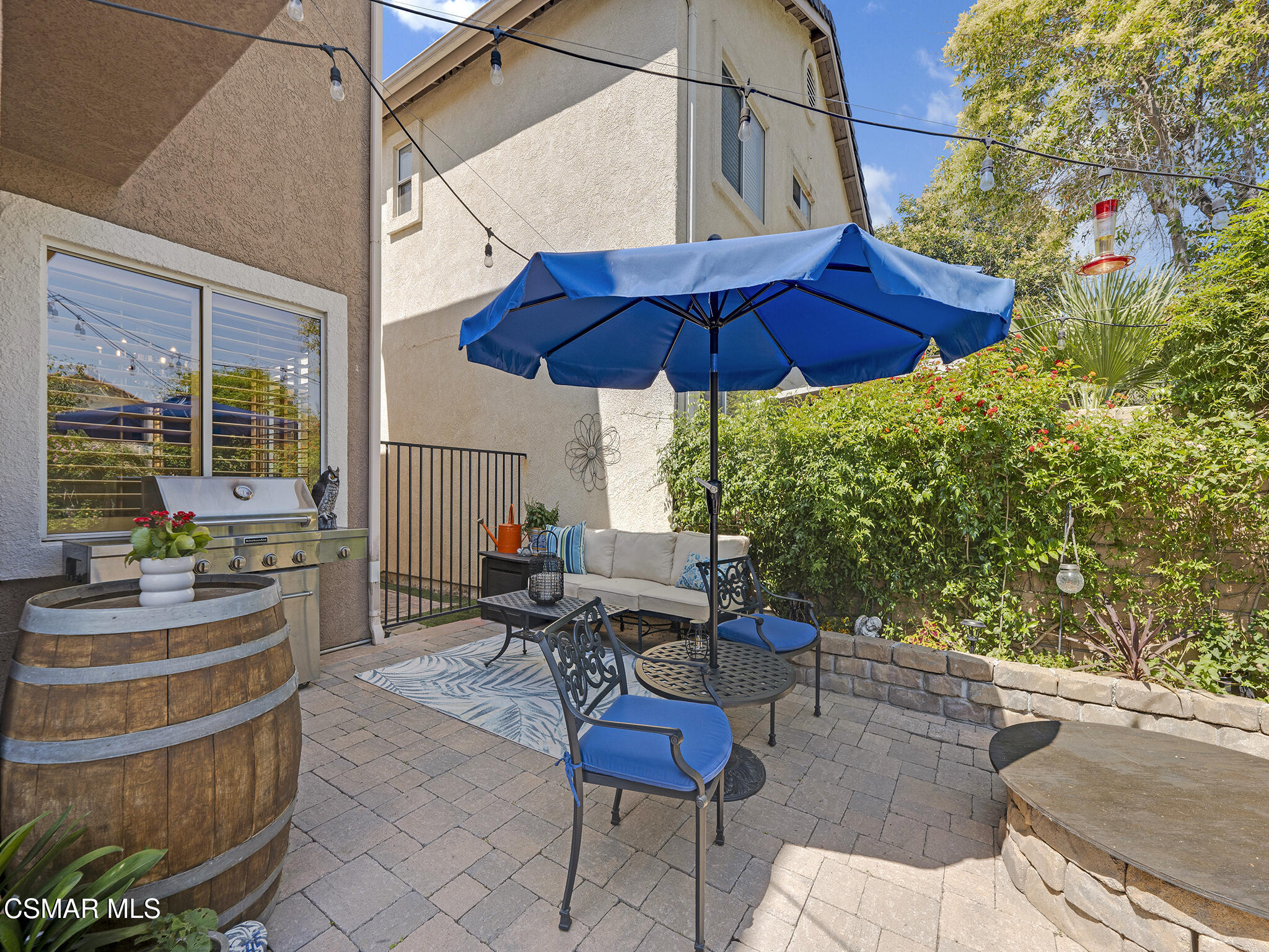 293 Springmist Lane Simi Valley, CA 93065 - Photo 32 of 50 a view of a patio with table and chairs under an umbrella