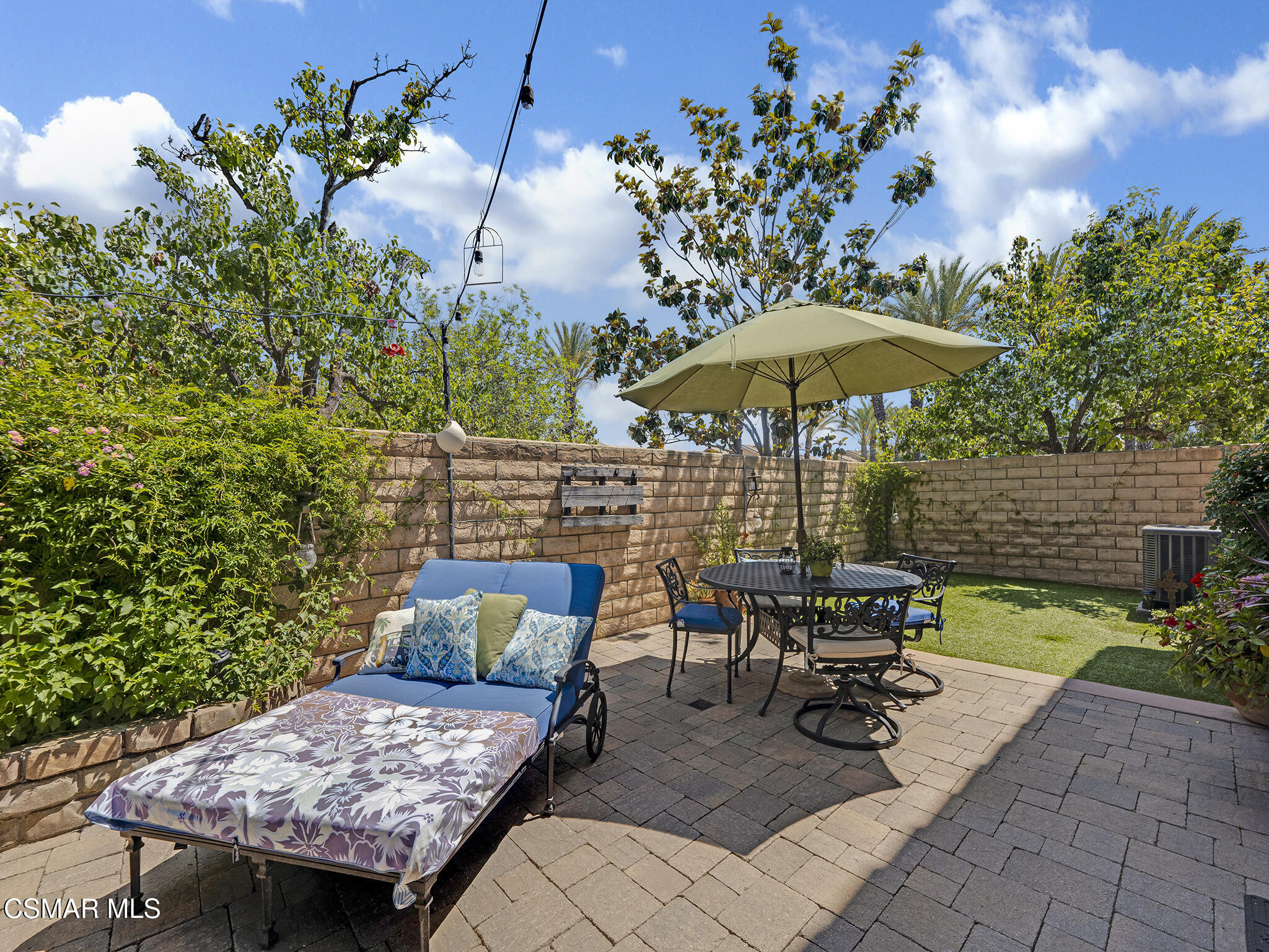 293 Springmist Lane Simi Valley, CA 93065 - Photo 34 of 50 a view of a patio with table and chairs under an umbrella with potted plants