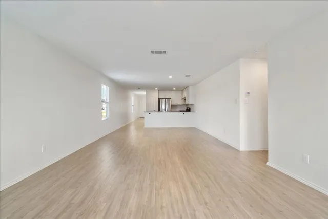 a kitchen with stainless steel appliances kitchen island granite countertop a stove a sink and a refrigerator
