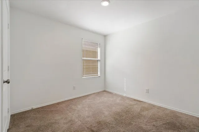 a bathroom with a granite countertop toilet and a sink