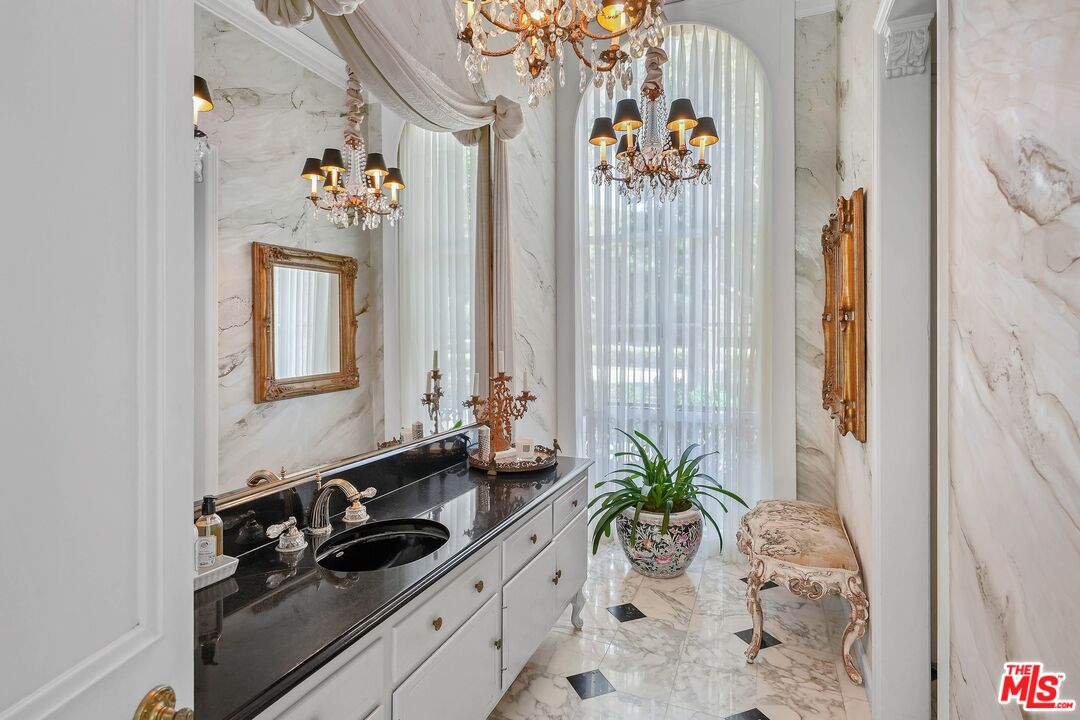 717 North Rodeo Drive Beverly Hills, CA 90210 - Photo 12 of 38 a bathroom with a sink a mirror and a window