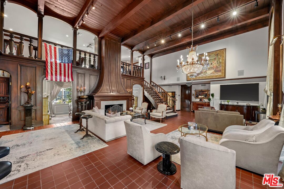 717 North Rodeo Drive Beverly Hills, CA 90210 - Photo 12 of 38 a living room with furniture a fireplace and a flat screen tv