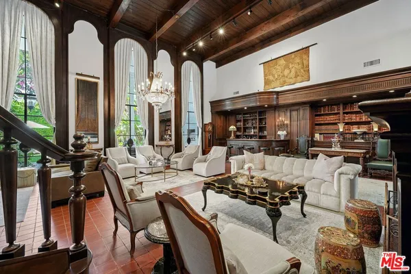 a view of a livingroom with furniture and floor to ceiling window