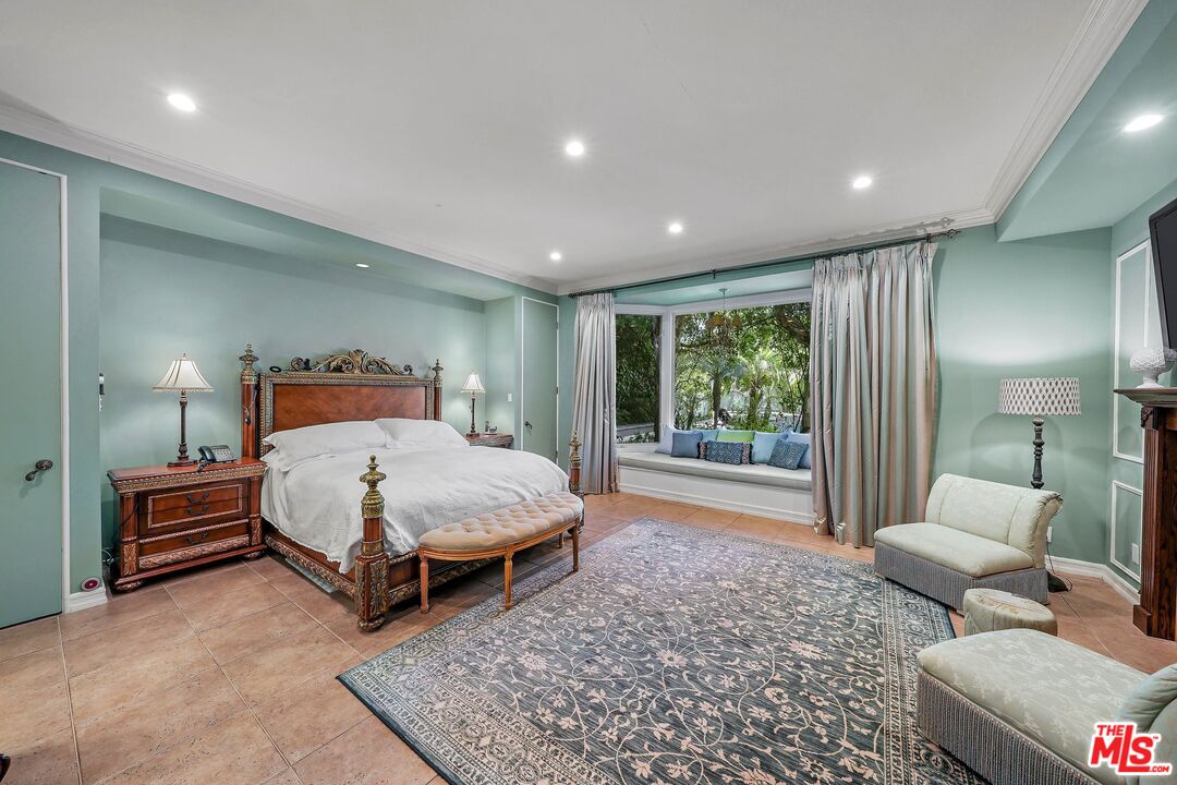 717 North Rodeo Drive Beverly Hills, CA 90210 - Photo 16 of 38 a bedroom with a bed and large window