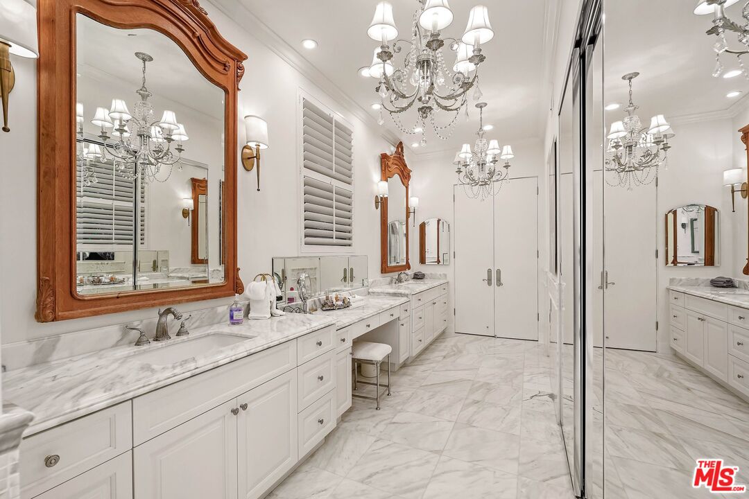 717 North Rodeo Drive Beverly Hills, CA 90210 - Photo 19 of 38 a spacious bathroom with double vanity a mirror a double vanity and a shower