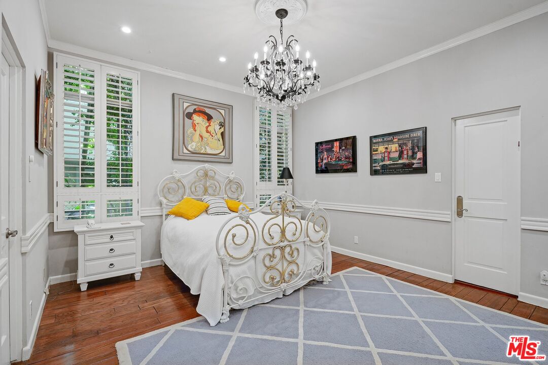 717 North Rodeo Drive Beverly Hills, CA 90210 - Photo 24 of 38 a bedroom with a bed and a window
