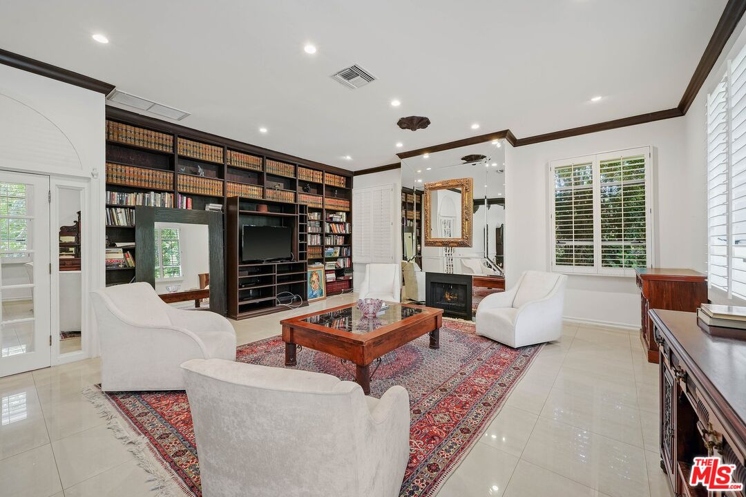 717 North Rodeo Drive Beverly Hills, CA 90210 - Photo 27 of 38 a living room with fireplace furniture and a large window