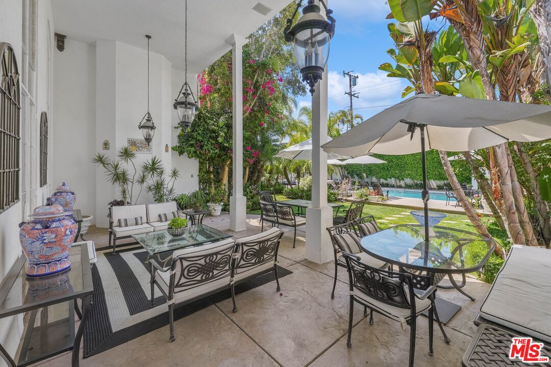 717 North Rodeo Drive Beverly Hills, CA 90210 - Photo 29 of 38 a living room with furniture and a potted plant
