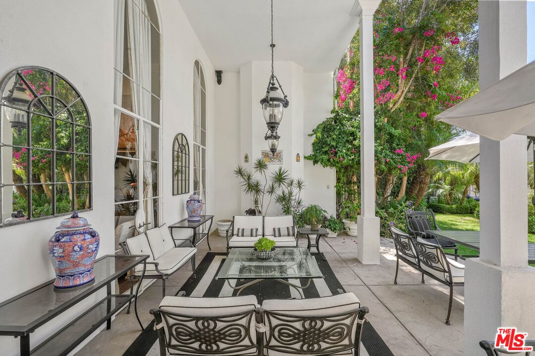 717 North Rodeo Drive Beverly Hills, CA 90210 - Photo 30 of 38 a view of a patio with couches table and chairs and potted plants