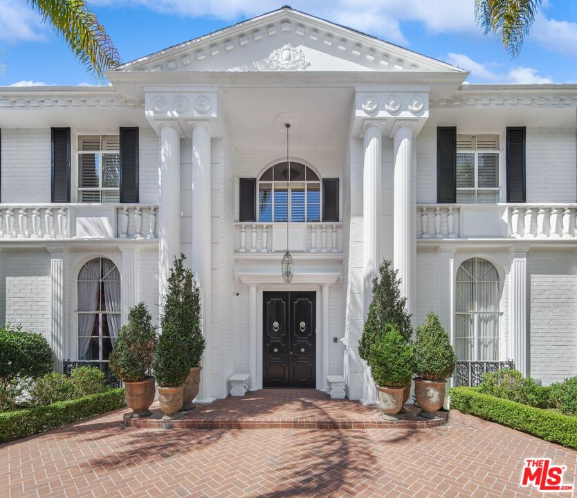 717 North Rodeo Drive Beverly Hills, CA 90210 - Photo 3 of 38 a front view of a house with garden