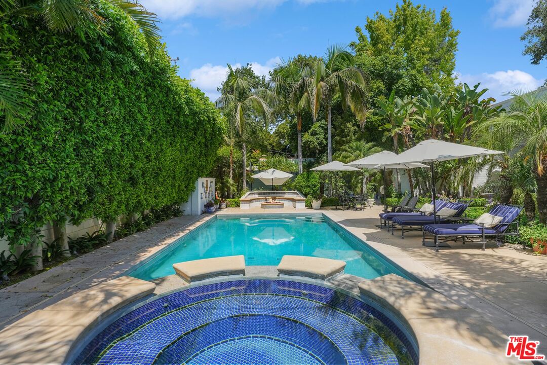 717 North Rodeo Drive Beverly Hills, CA 90210 - Photo 33 of 38 an outdoor sitting area with furniture and umbrella