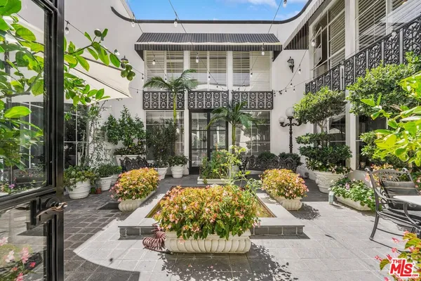 a view of a building with garden and sitting area