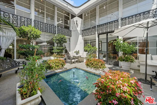 a view of a swimming pool with outdoor seating