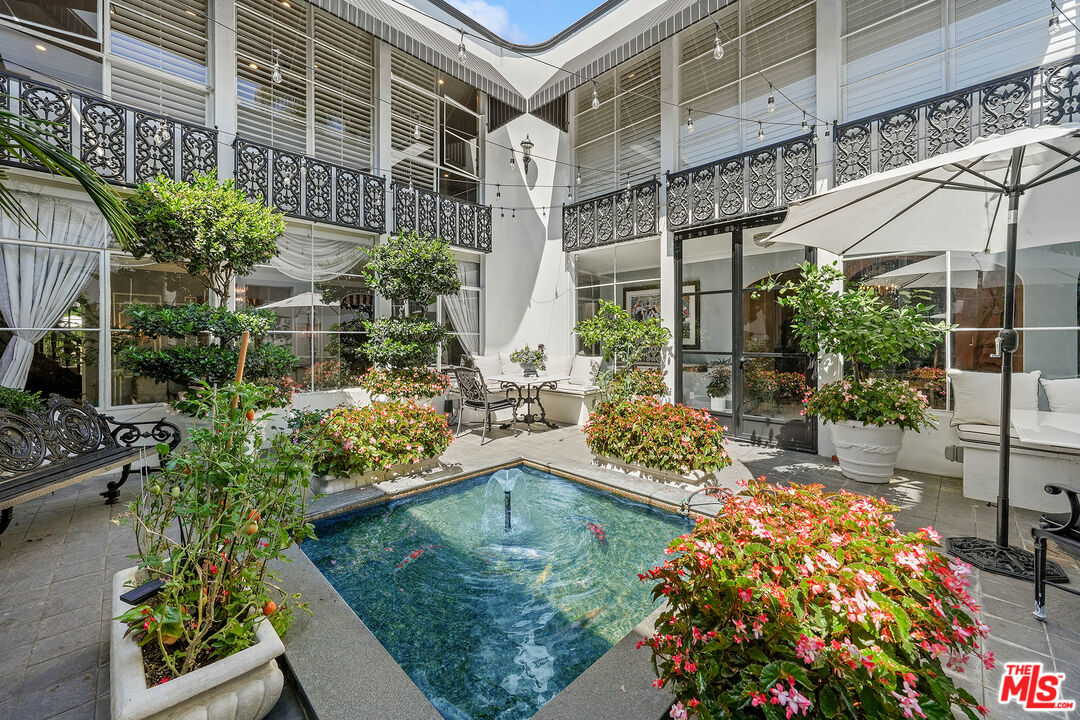 717 North Rodeo Drive Beverly Hills, CA 90210 - Photo 9 of 38 a view of a swimming pool with outdoor seating