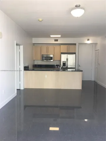 a kitchen with stainless steel appliances granite countertop a sink and a stove