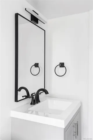 a bathroom with a sink and mirror