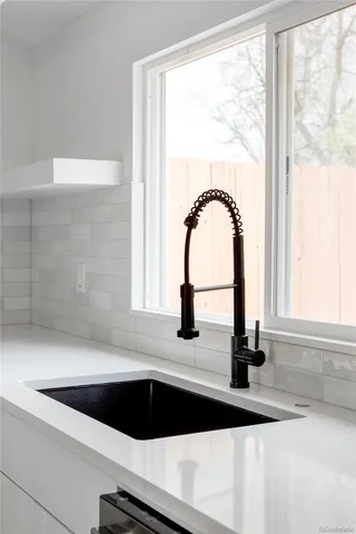 a close view of a sink a mirror and a window