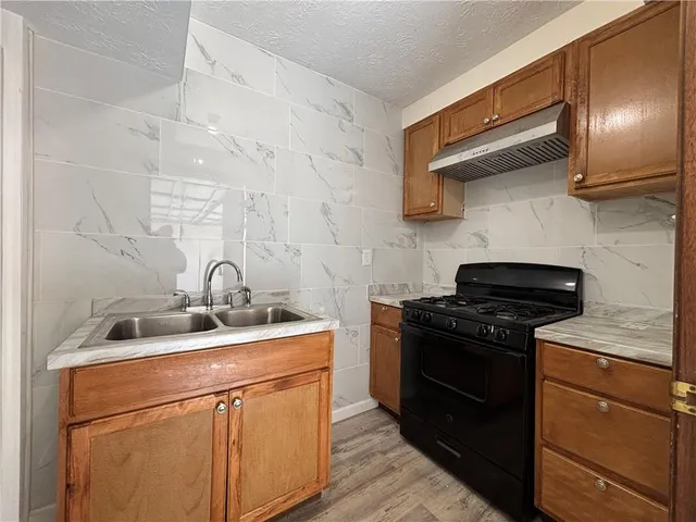 a view of a yard with wooden fence