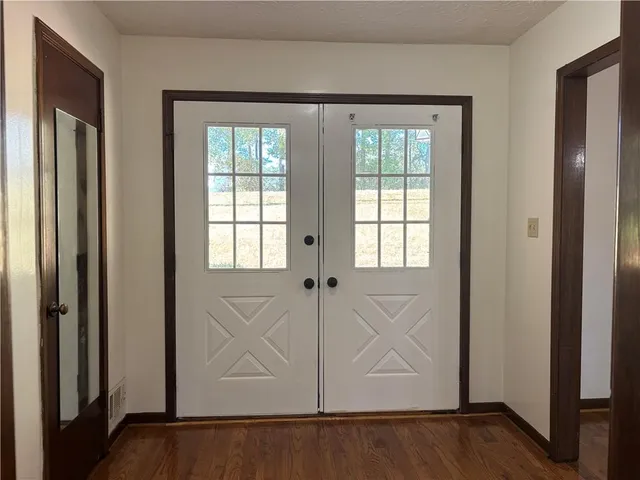 a view of an entryway with wooden floor