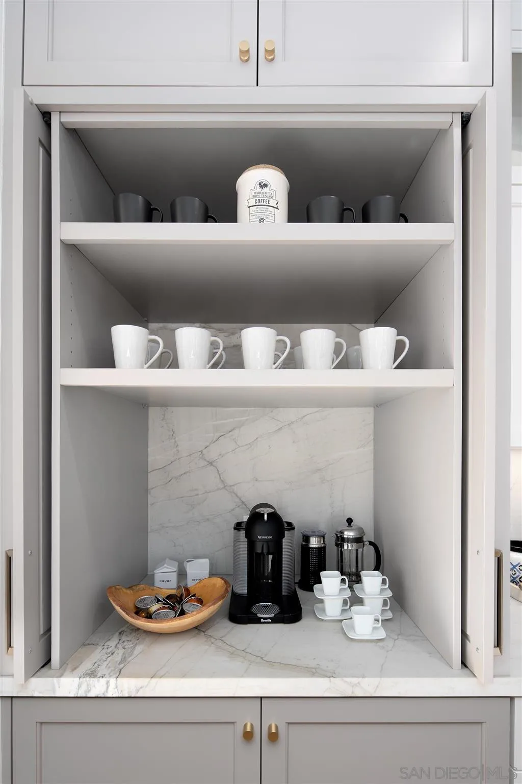 425 South Rios Avenue Solana Beach, CA 92075 - Photo 13 of 50 a shelf with books and knick knacks on it