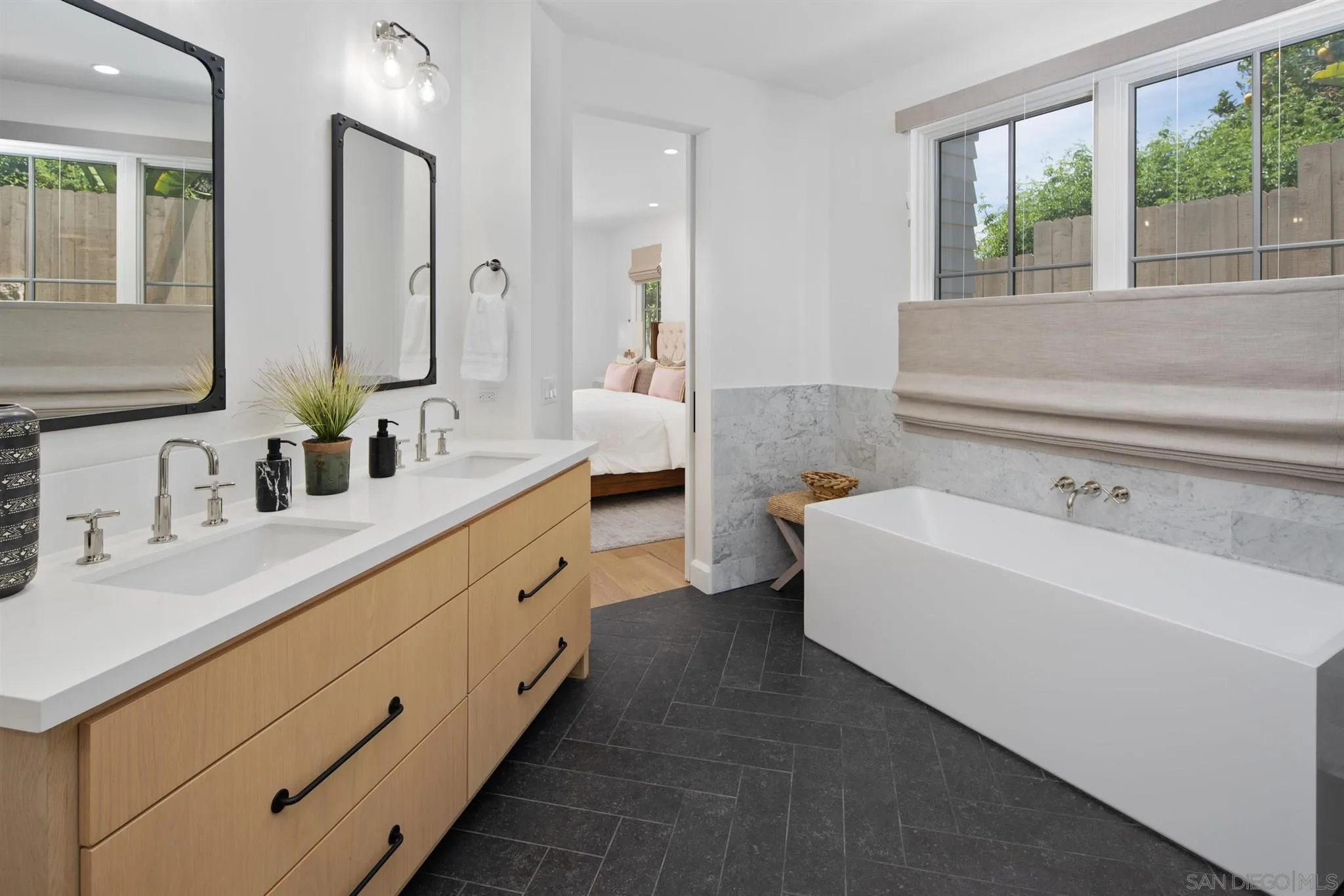 425 South Rios Avenue Solana Beach, CA 92075 - Photo 20 of 50 a bathroom with a double vanity sink a mirror and a bathtub