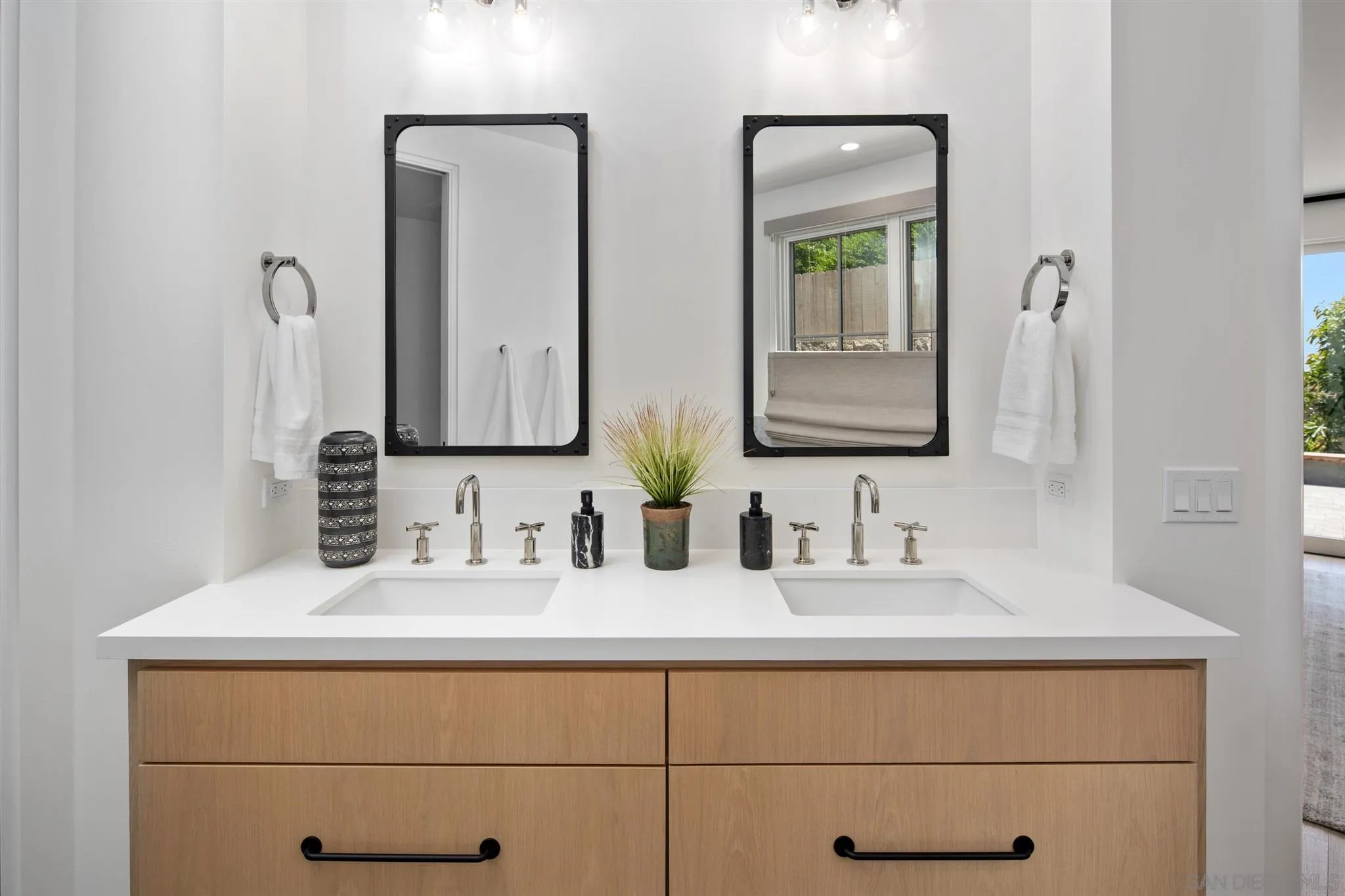 425 South Rios Avenue Solana Beach, CA 92075 - Photo 21 of 50 a bathroom with double vanity sinks and a mirror