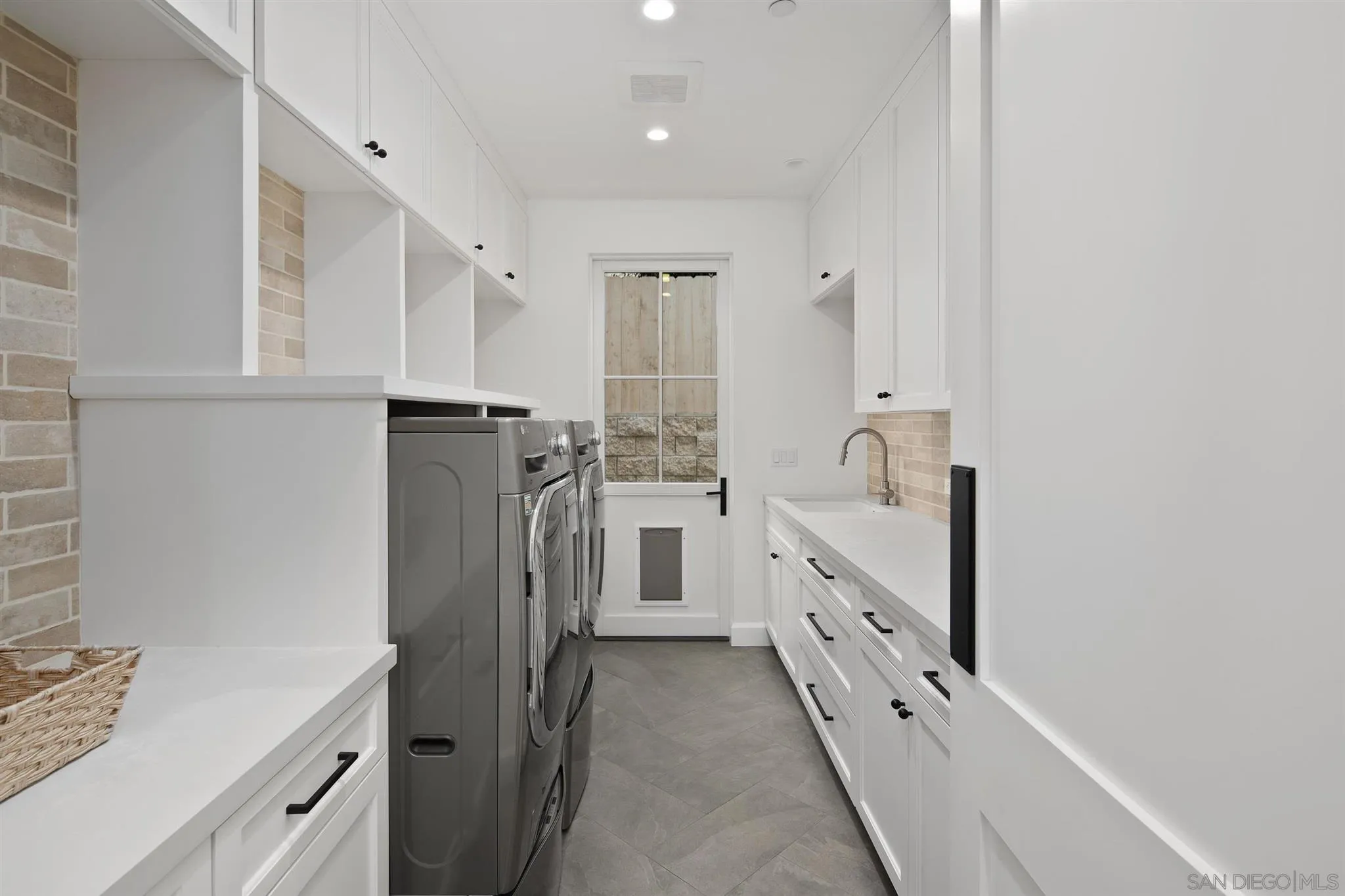 425 South Rios Avenue Solana Beach, CA 92075 - Photo 30 of 50 a bathroom with white cabinets and a sink