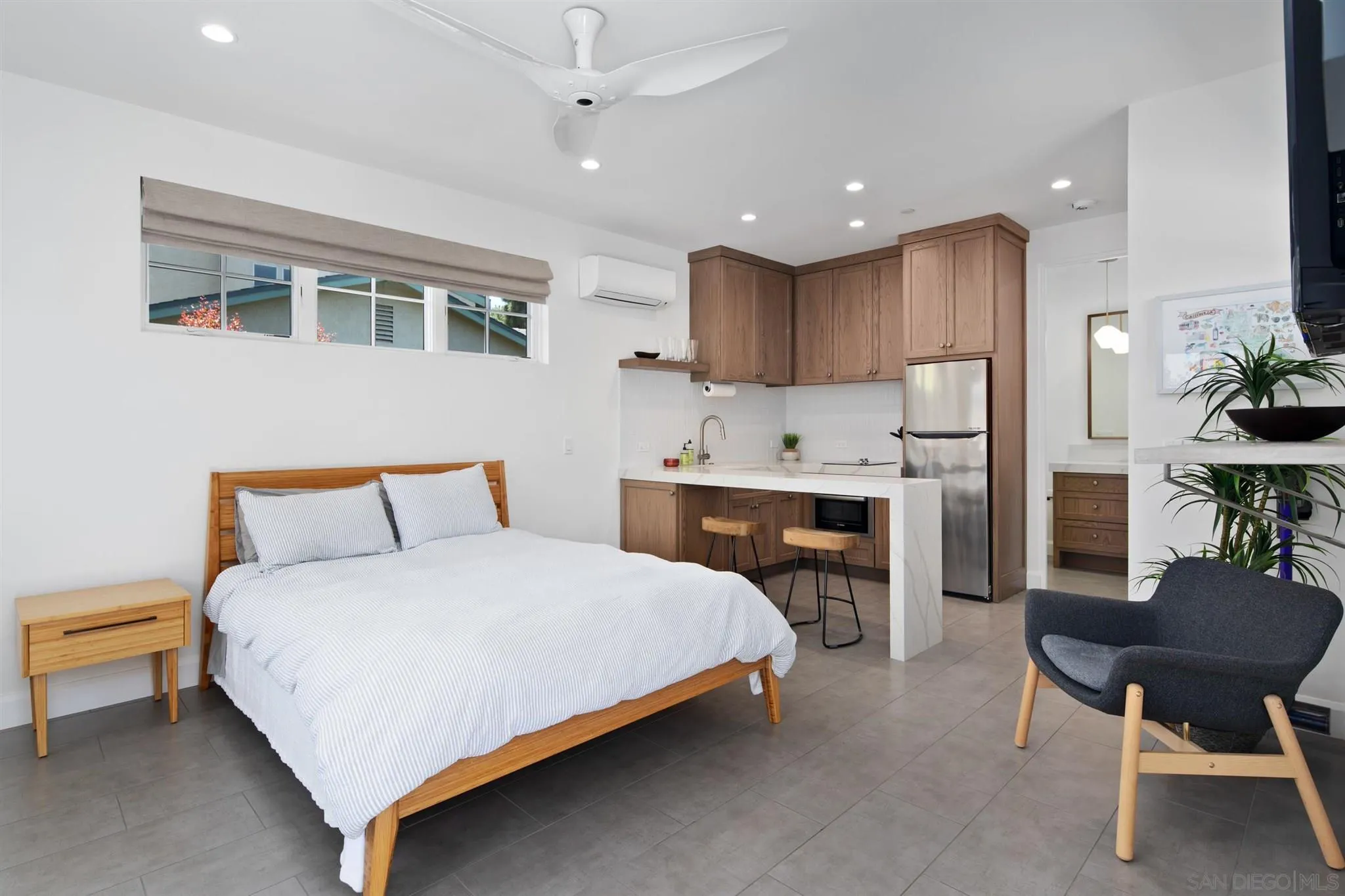 425 South Rios Avenue Solana Beach, CA 92075 - Photo 32 of 50 a spacious bedroom with a bed a table and chair