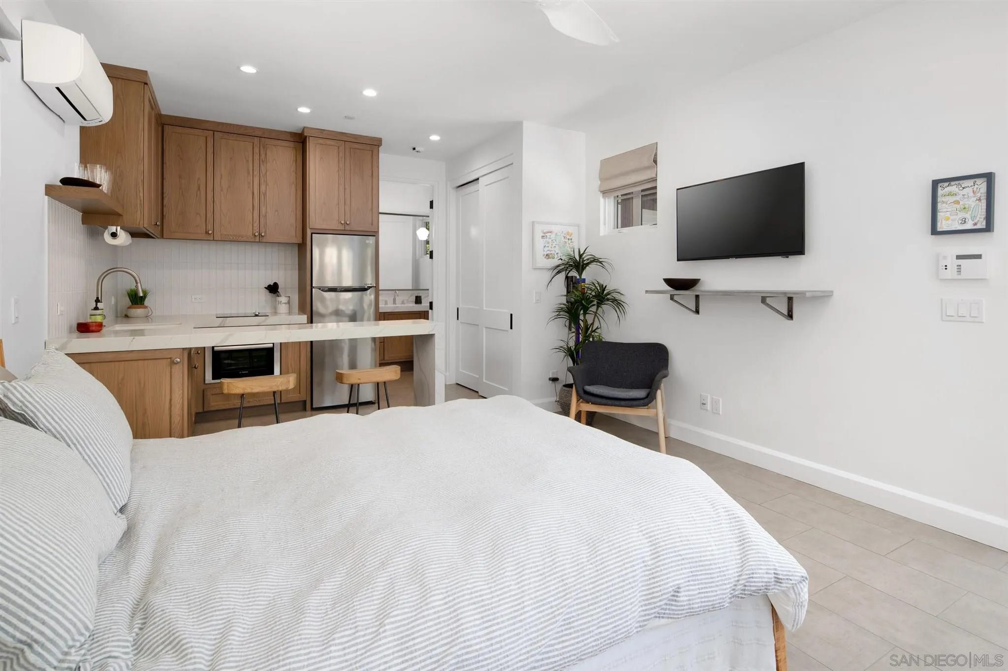 425 South Rios Avenue Solana Beach, CA 92075 - Photo 33 of 50 a bedroom with a bed and a flat screen tv