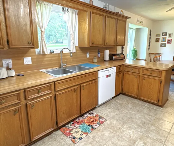 a kitchen with appliances cabinets and furniture