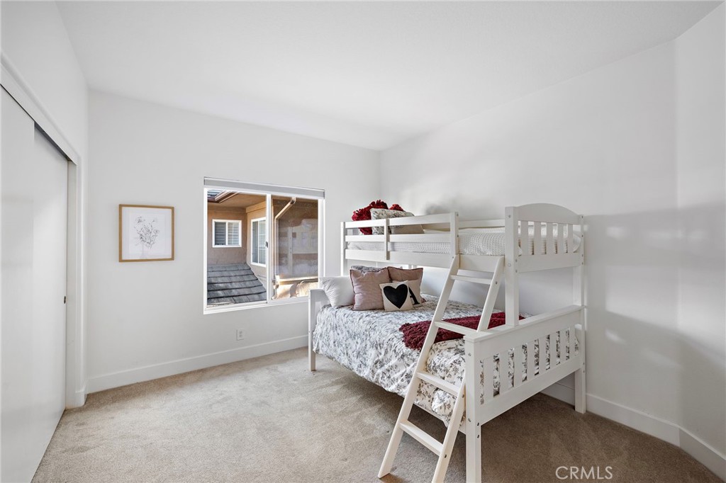 19361 Jasper Hill Road Lake Forest, CA 92679 - Photo 11 of 37 a bedroom with a bed a chandelier and closet