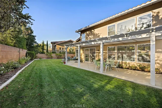 a view of a house with backyard porch and sitting area