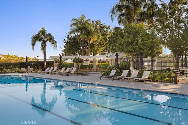a view of swimming pool with outdoor seating and plants