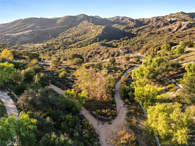 a view of a house with a mountain and a forest