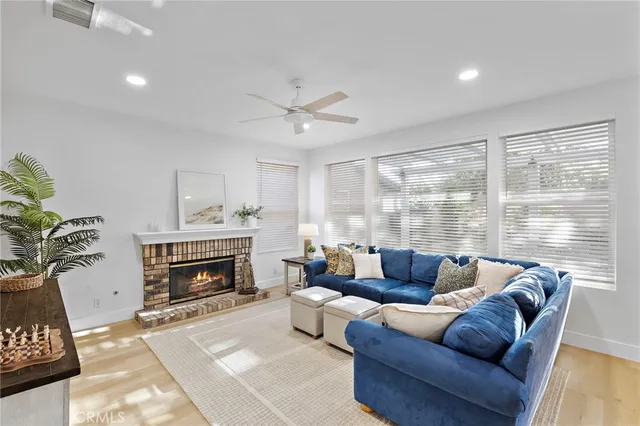 a living room with furniture a large window and a fireplace