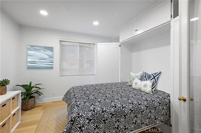 a bedroom with a large bed and a potted plant