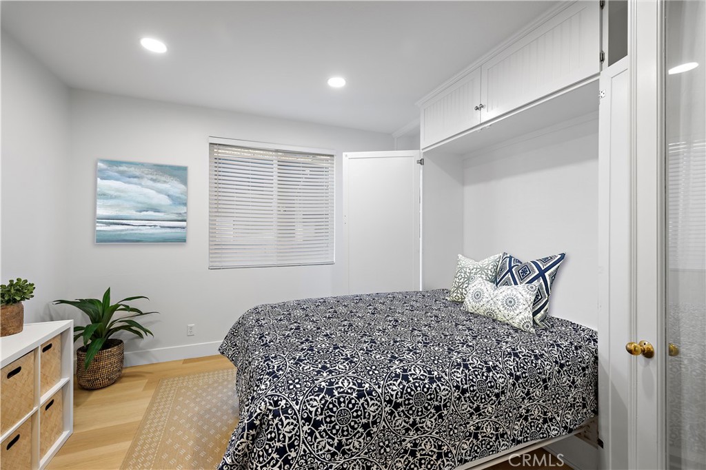 19361 Jasper Hill Road Lake Forest, CA 92679 - Photo 7 of 37 a bedroom with a large bed and a potted plant