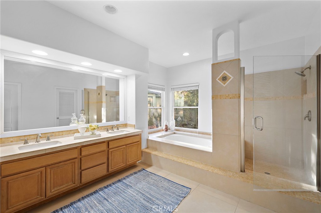 19361 Jasper Hill Road Lake Forest, CA 92679 - Photo 10 of 37 a spacious bathroom with a shower sink and mirror