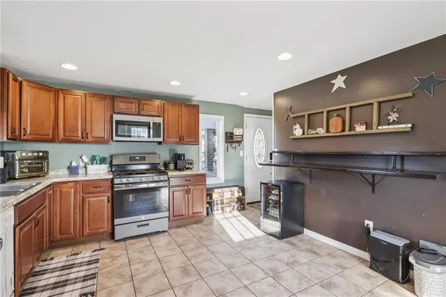 a kitchen with stainless steel appliances granite countertop a stove top oven a sink dishwasher and cabinets