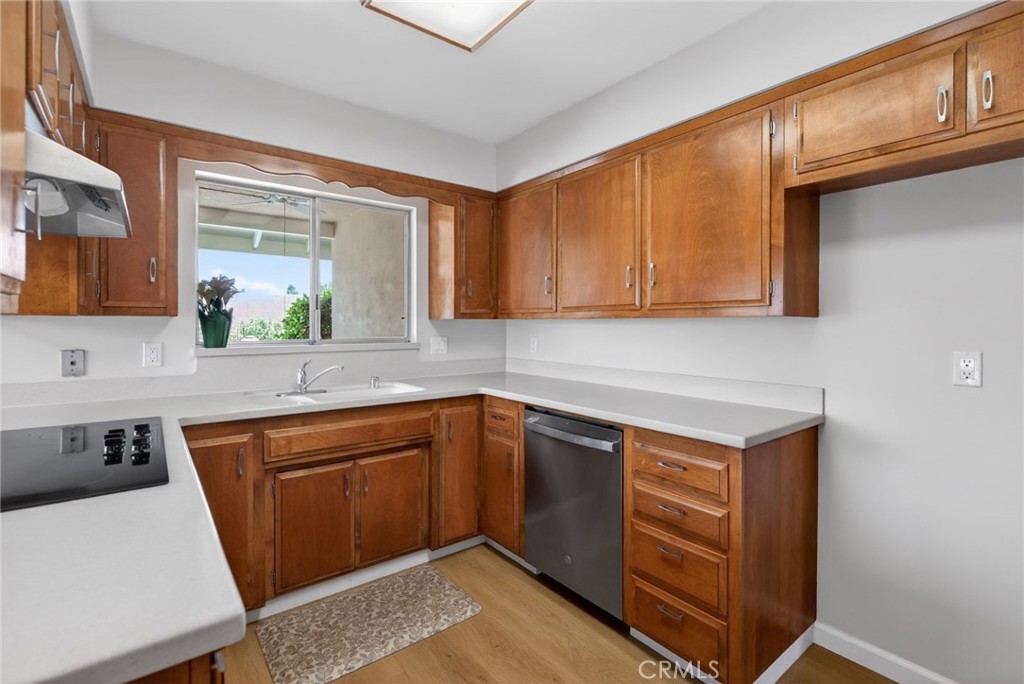 4963 Carlingford Avenue Riverside, CA 92504 - Photo 9 of 33 a kitchen with stainless steel appliances granite countertop a sink stove and cabinets