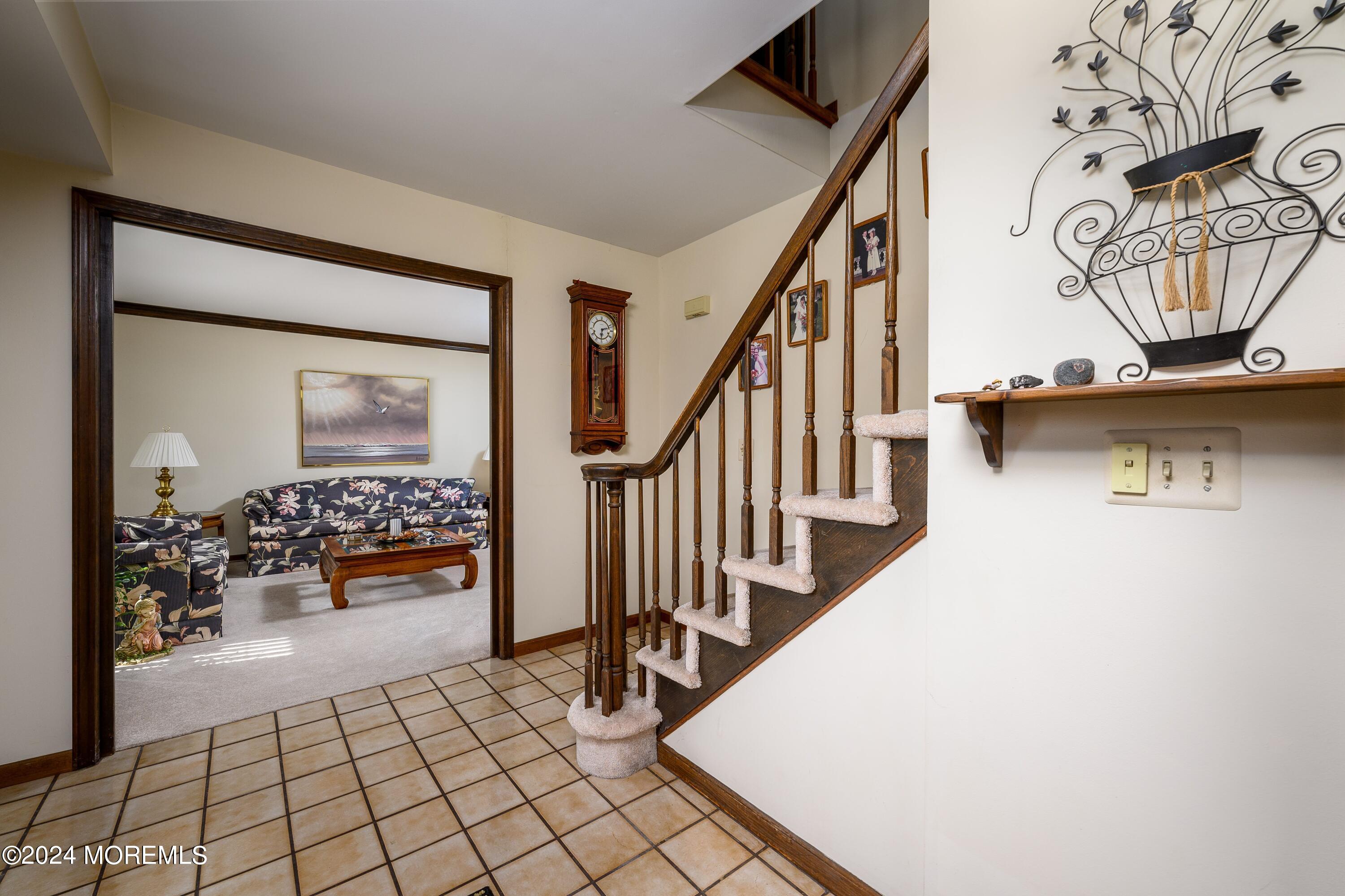 14 Spicy Pond Road Howell, NJ 07731 - Photo 12 of 35 a view of a livingroom with wooden floor and a stairs